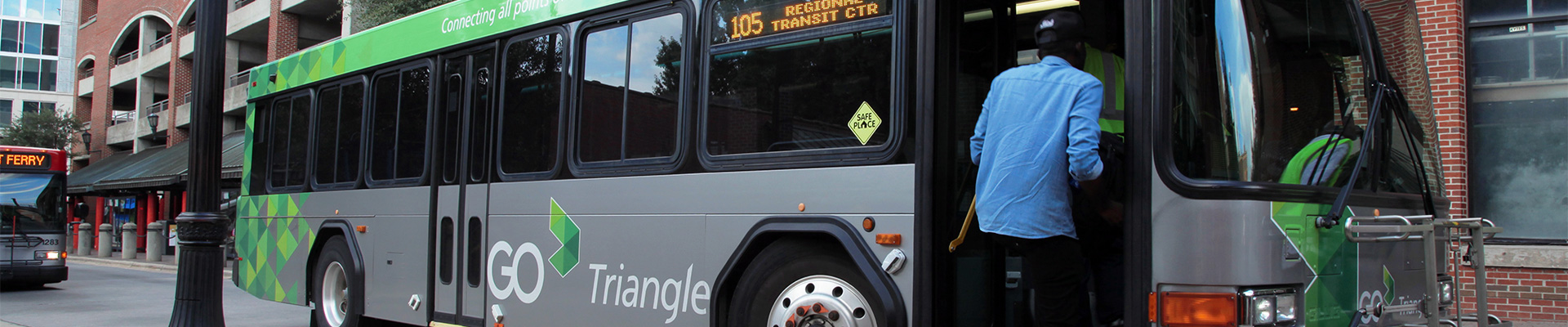 Man boards GoTriangle bus parked in Moore Square