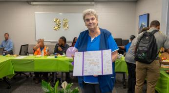 Tilly Reames holds a retirement card